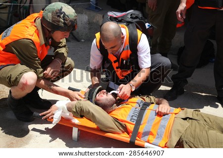 ATLIT, ISRAEL - JUNE 03, 2015: Paramedics treat rocket attack casualties in Carmel Prison during simulation drill Turning Point 15. Emergency forces practice rescue and first aid treatment to injured