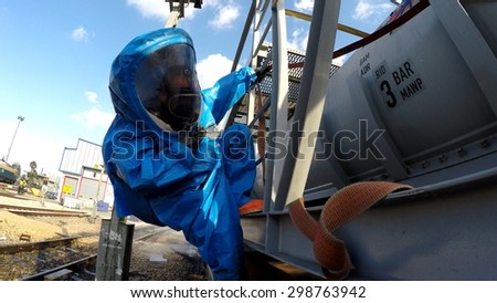 HAIFA, ISRAEL - JUNE 30, 2015: Firefighters from Northern Israel with protective gear during simulation drill  seal leak of Bromine chemical in a container car of train.