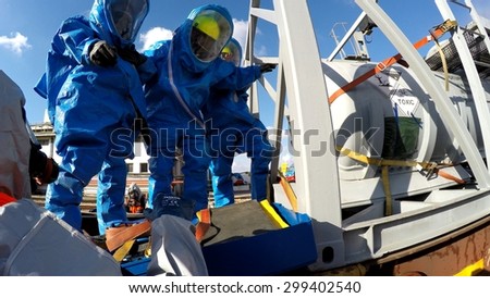 HAIFA, ISRAEL - JUNE 30, 2015: Firefighters from Northern Israel with protective gear make a decision during simulation drill of leak of Bromine chemical in a container car of train