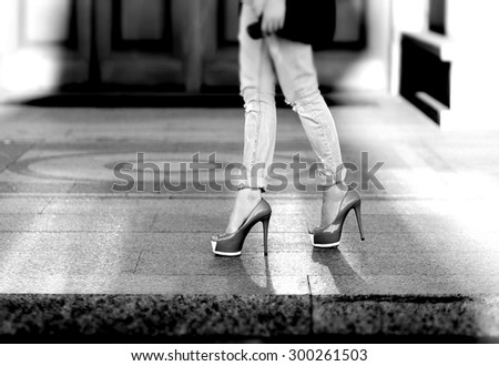Female legs in heels (black-and-white photo)