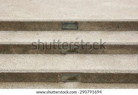 Brown concrete stairs with three steps.