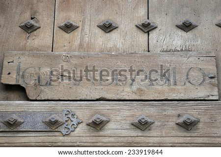 Wooden sign on the door of a church