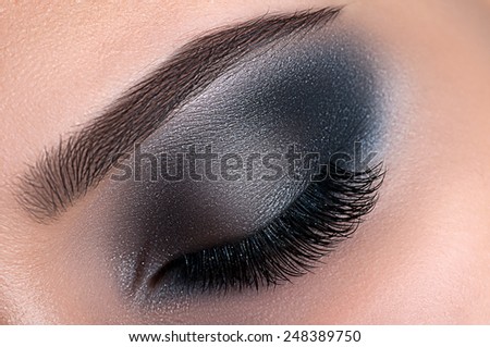 Beautiful creative eye make-up black smoke eyes close up
