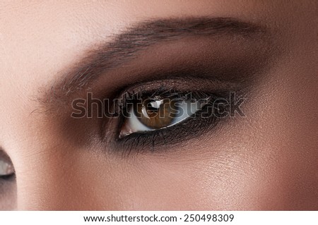 Creative eye makeup. Fashionable smoke eyes. Cosmetics and make-up. Dark eye makeup. With dark black eye makeup.