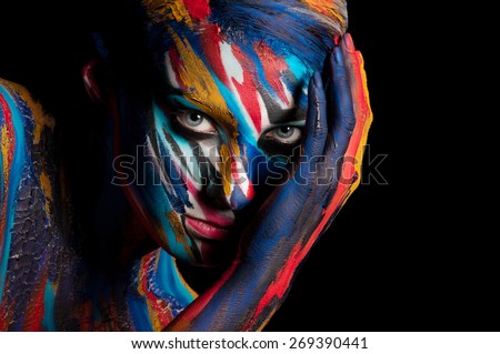 Beautiful body art on the body of the girl. Paint on the girl\'s face.