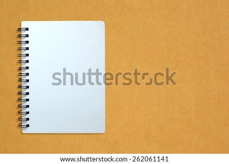 White page of notebook on yellow cardboard paper