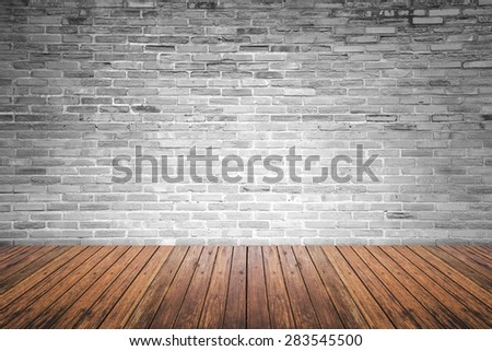 Old interior room with broken gray brick wall and grunge wood floor texture