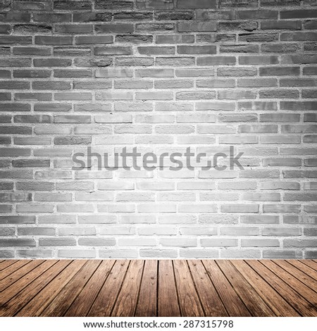 Old interior room with broken gray brick wall and grunge wood floor texture