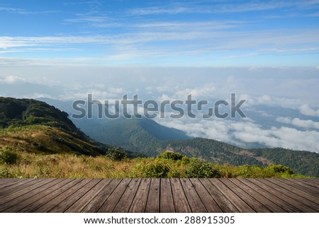 aerial view of scenic mountain landscape and wood floor texture on foreground