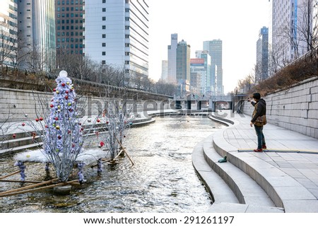 SEOUL, SOUTH KOREA - OCTOBER 3, 2014 : People at Cheonggyecheon stream in winter. The stream is a modern public recreation space in downtown Seoul, South Korea.