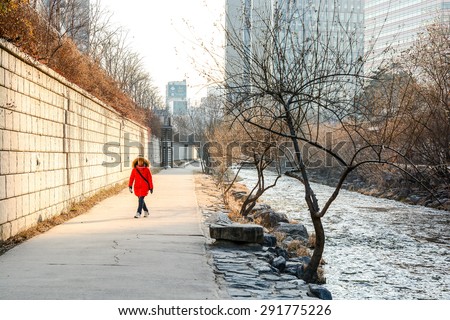 SEOUL, SOUTH KOREA - OCTOBER 3, 2014 : People at Cheonggyecheon stream in winter. The stream is a modern public recreation space in downtown Seoul, South Korea.
