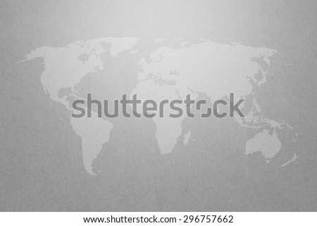 world map graphic on gray paper texture background with light on top