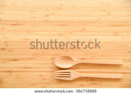 Dinner Table Background wooden spoon and fork on wood texture of dining table from top Dinner Table Background wooden spoon and fork on wood texture of dining table from top
