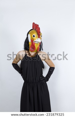 Woman wearing a cock mask with an evening dress and evening gloves