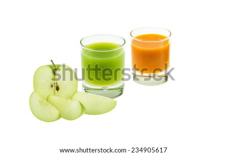 Small grass of blended orange, grapefruit and cut of green apple on white background