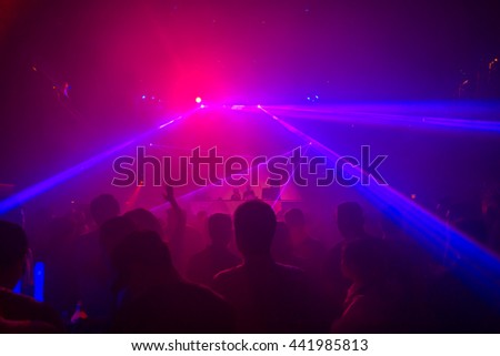 Blurry night club dj party people enjoy of music dancing sound with colorful light.