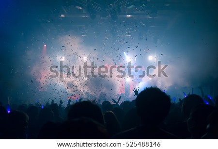 Silhouette hands of audience crowd people use smart phones enjoying the club party with concert. Celebrate new year party , Blurry night club DJ party people enjoy of music dancing sound .