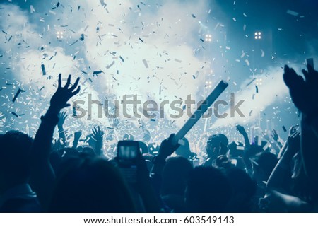 Silhouette hands of audience crowd people use smart phones enjoying the club party with concert. Celebrate new year party , Blurry  people movement  enjoy of music dancing sound .