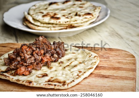 Mexican cuisine. Fried tortilla with meat. Cooking processes. Toned