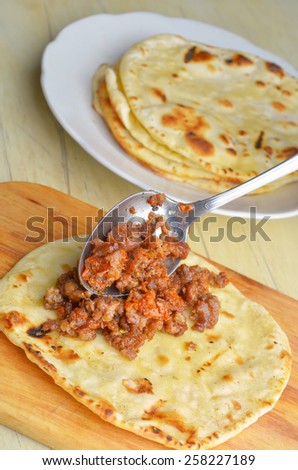 Mexican cuisine. Fried tortilla with meat. Cooking processes.