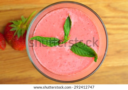 Top view of strawberry smoothies (on blurred old wood table)