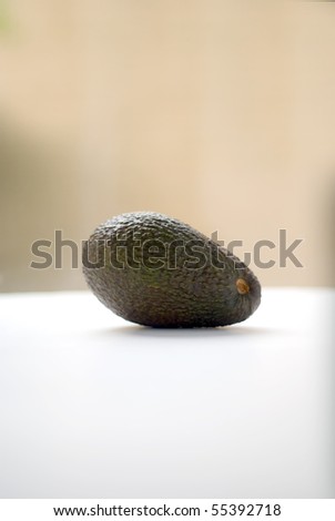 A Hass variety avocado bathed in natural light - shallow depth of field in portrait orientation