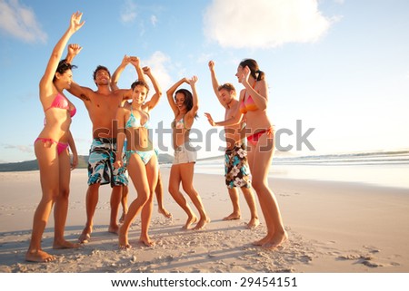 stock photo Portrait of happy teenagers dancing on the beach