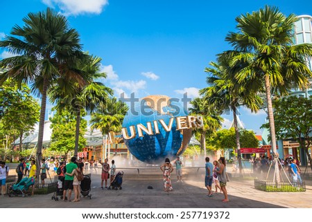 SINGAPORE - JANUARY 13 Tourists and theme park visitors taking pictures of the large rotating globe fountain in front of Universal Studios on January 13, 2015 in Sentosa island, Singapore