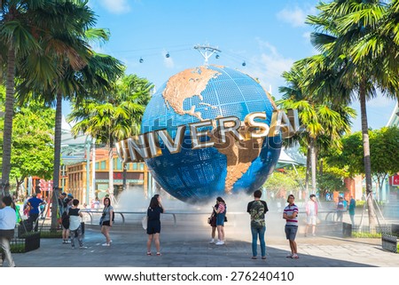 SINGAPORE - JANUARY 26 Tourists and theme park visitors taking pictures of the large rotating globe fountain in front of Universal Studios on January 26, 2014 in Sentosa island, Singapore