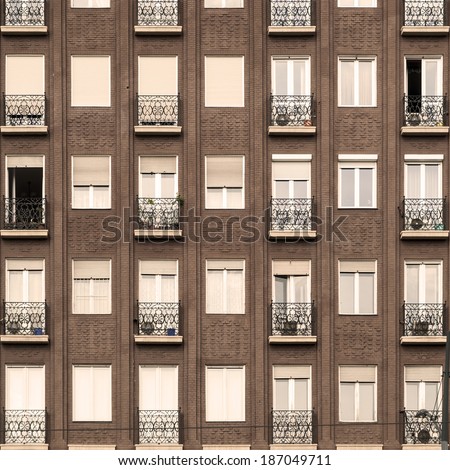 Facade of a block of flats with balcony and windows square image
