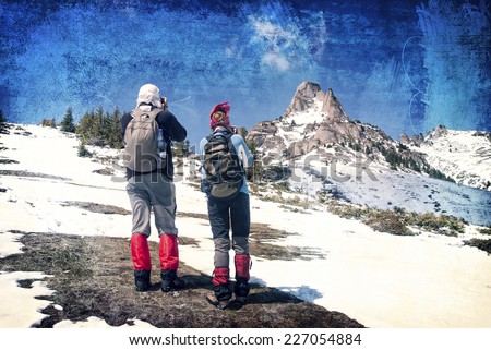 Tourists climbing to the peaks in winter on grungy background