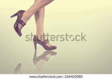 Legs of a woman wearing high heels shoes