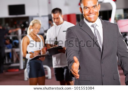friendly gym manager hand shake gesture