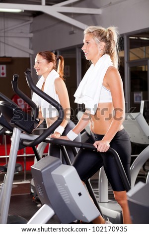 fitness women using stepper machine in gym