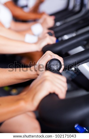 closeup of hands on gym bikes