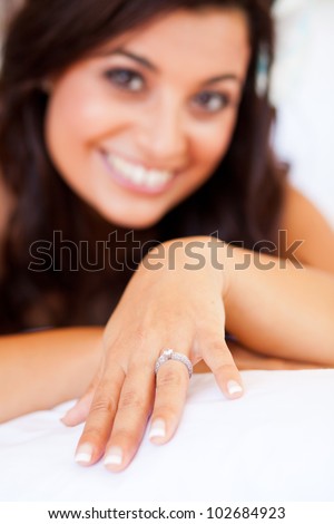 happy bride showing her wedding ring