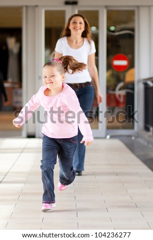 little girl running in front mother