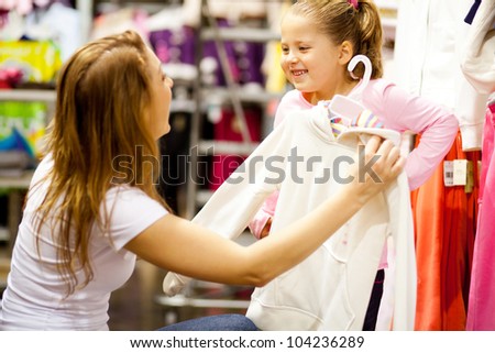 mother and daughter shopping for clothes