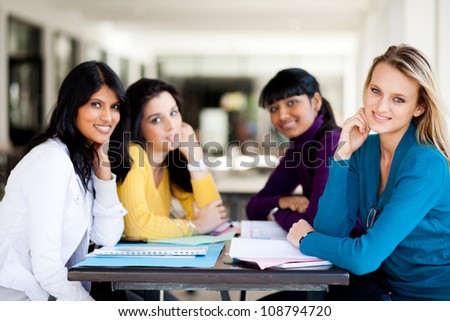 group of female college students sitting by school cafeteria