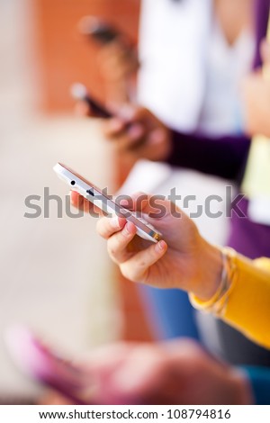 closeup of group young people using smart phone