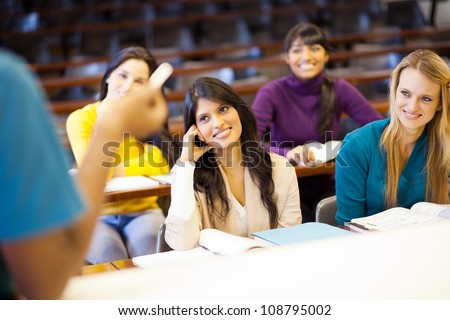 college professor lecturing group of students in classroom
