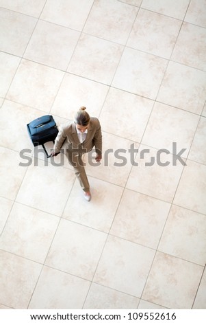 overhead view of young woman walking at airport