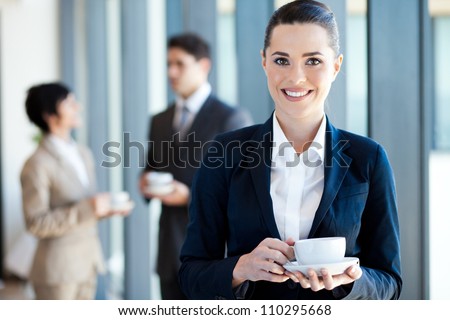 young businesswoman having coffee break at work