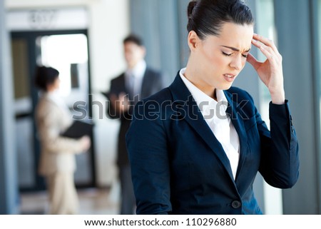 young businesswoman having headache at work