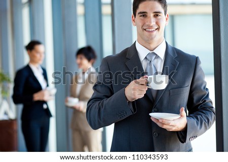 young businessman having coffee break in office