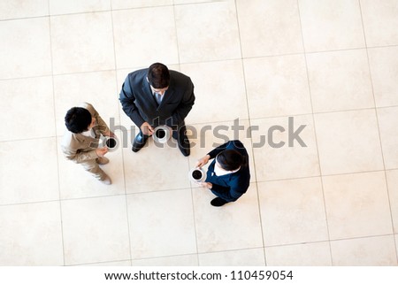 group of co-workers having coffee break at work