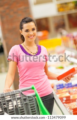 happy young woman shopping for frozen food in supermarket