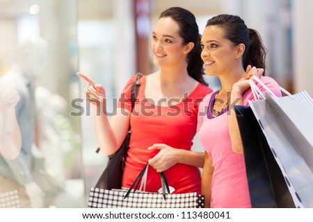 two young women shopping in mall