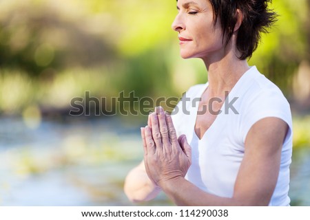 middle age woman doing yoga meditation