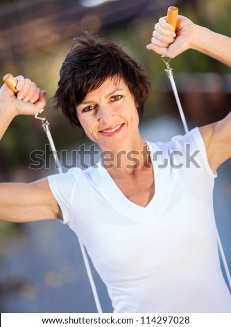 active middle aged woman with jumping rope